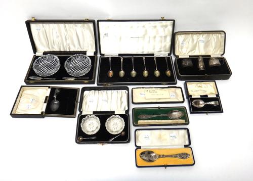 Silver and faceted glassware, comprising; six rat tail pattern coffee spoons, three condiments, four christening spoons, a pair of glass salts with tw