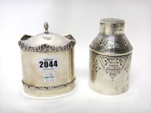A silver oval hinge lidded tea caddy, decorated with a cast floral border, probably Birmingham 1911 and a Victorian silver tea caddy, of cylindrical f