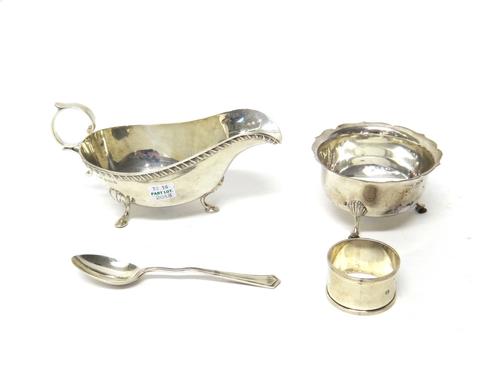 Silver, comprising; a sauceboat, decorated with a gadrooned rim, raised on three feet, Birmingham 1934, a sugar bowl, raised on three feet, Sheffield