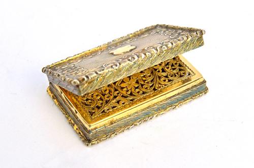 A Victorian silver gilt rectangular vinaigrette, with a floral and scroll engraved and pierced grille, the exterior engine turned to the centre, withi