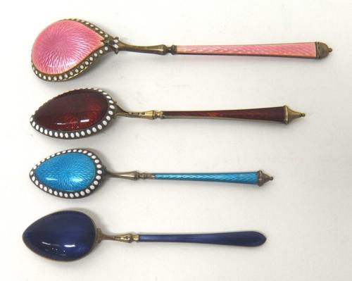 A Swedish silver gilt and pink enamelled spoon, detailed 925 and three smaller Scandinavian gilt and enamelled spoons, comprising; mauve, pale blue an