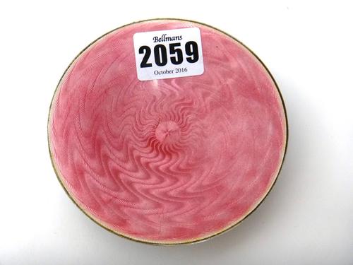 A silver and translucent pink enamelled circular dish, raised on three spherical feet, import mark London 1916, diameter 10.4cm, gross weight 103 gms.