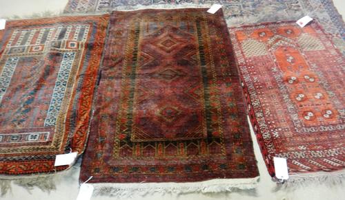 An Afghan prayer rug, 124cm x 80cm, and two Belouche rugs, (3).  G2