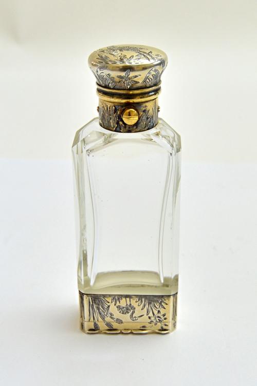 A Victorian silver gilt mounted double ended faceted glass vinaigrette cum scent bottle, the base formed as a vinaigrette, gilt within, the exterior w