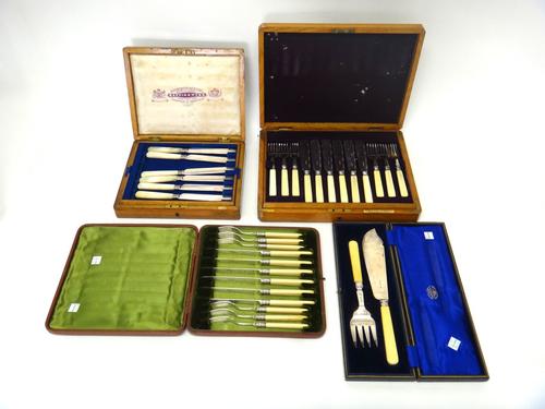 A pair of silver fish servers, by Goldsmiths & Silversmiths Company, London 1928, cased, a set of six pairs of plated dessert knives and forks, cased,