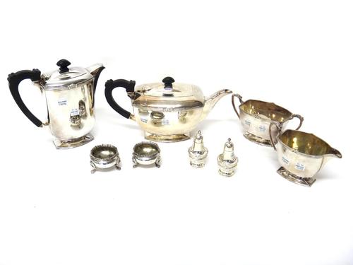 A pair of silver circular salts, each raised on three lion mask feet, (the hallmarks rubbed), a pair of pepperettes, detailed Sterling Silver and a pl