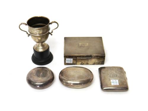 Silver and silver mounted wares, comprising; an oval tobacco box, Birmingham 1925, a circular tobacco box, Birmingham 1899, a cigarette case, a cigare