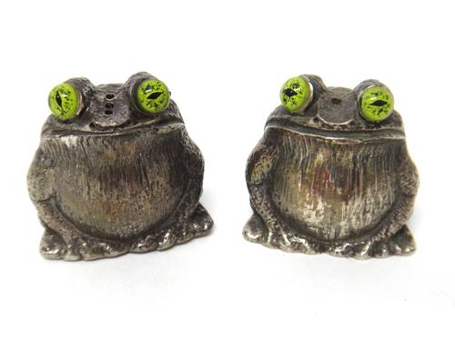 A pair of silver novelty salt and pepper pots, designed as frogs with green glass eyes, modern, combined gross weight 163 gms, (2).
