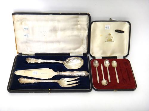 Three similar silver serving implements, comprising; a serving slice and fork, Birmingham 1922 and a serving spoon, Birmingham 1928, with a case and f