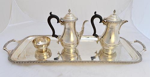 Silver, comprising; a rectangular twin handled tray, decorated with a gadrooned rim, Birmingham 1933, weight 1390 gms, a coffee pot and a hot milk jug