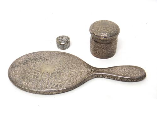 Eastern wares, comprising; a large oval hand mirror, decorated with floral scrolls, a cylindrical jar and cover, similarly decorated and a smaller cir