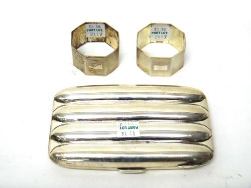 A silver rectangular cigar case, to hold four cigars, Birmingham 1924, a pair of silver octagonal napkin rings, with engine turned decoration, Birming