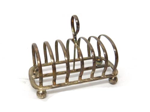 A silver seven bar toastrack, with a loop shaped handle and raised on four spherical feet, by Mappin & Webb Ltd, Sheffield 1935, weight 295 gms.