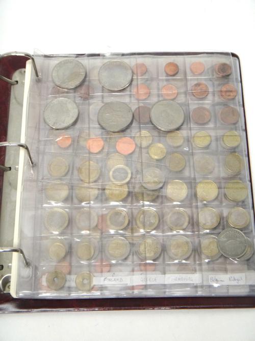 A collection of modern British, Colonial and foreign coinage, including five pound coins, two pound coins, one pound coins and fifty pence coins, disp