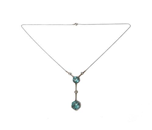 A blue zircon and diamond set pendant necklace, claw set with two circular cut blue zircons and with three collet set cushion shaped diamonds mounted