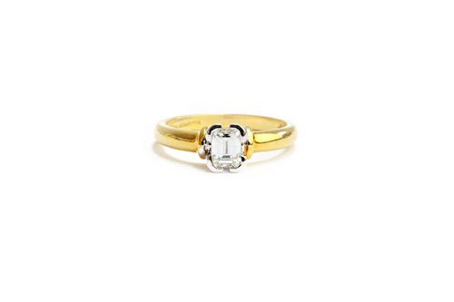An 18ct gold and diamond single stone ring, mounted with a cut cornered rectangular emerald cut diamond, estimated weight of the diamond 0.50 cts, rin
