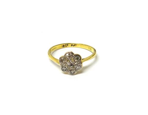 An 18ct gold and platinum, diamond set seven stone cluster ring, mounted with cushion shaped diamonds, detailed 18 CT PLAT, ring size Q.