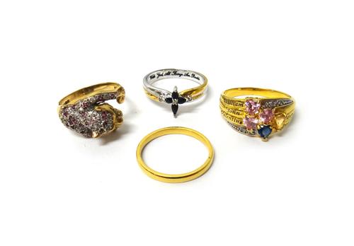 A silver and gilt, sapphire and diamond ring, mounted with four pear shaped sapphires and with three small diamonds, a 9ct gold, ruby and colourless g
