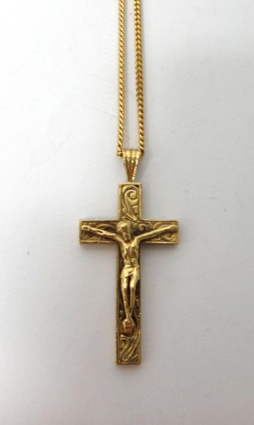 A 9ct gold pendant crucifix, with a 9ct gold faceted curb link neckchain, on a boltring clasp, combined weight 13.7 gms, (2).