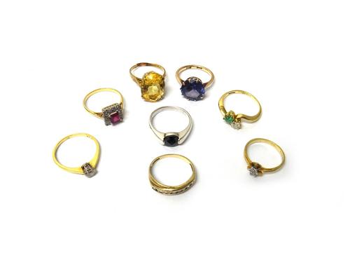 An 18ct gold, diamond and green gem set ring, in a cross over design, an 18ct gold and diamond set single stone ring, claw set with a circular cut dia