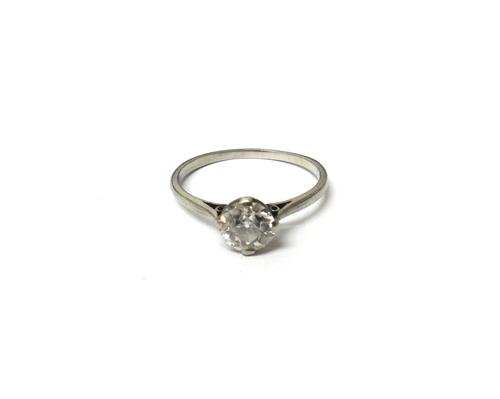A diamond set single stone ring, claw set with a cushion shaped diamond, ring size L and a half, with a case.