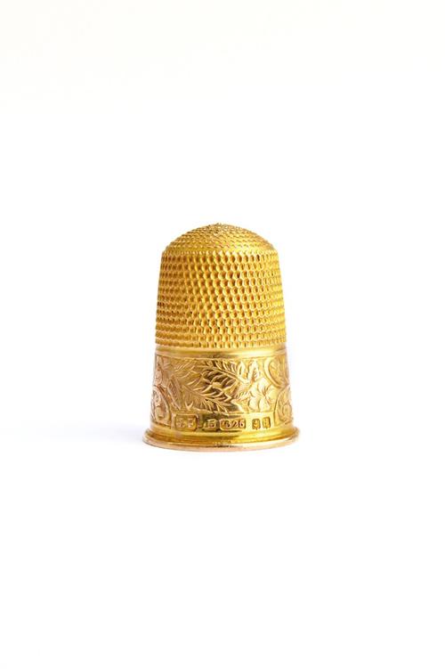 A 15ct gold thimble, with floral, foliate and scroll engraved decoration, Birmingham 1903, weight 5.2 gms, with a case. Illustrated