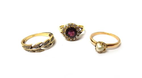 A gold, garnet and diamond set cluster ring, claw set with the cushion shaped garnet to the centre, in a surround of cushion shaped diamonds, a 9ct go