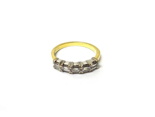 An 18ct gold and diamond set five stone ring, mounted with a row of cut cornered rectangular emerald cut diamonds, ring size N.