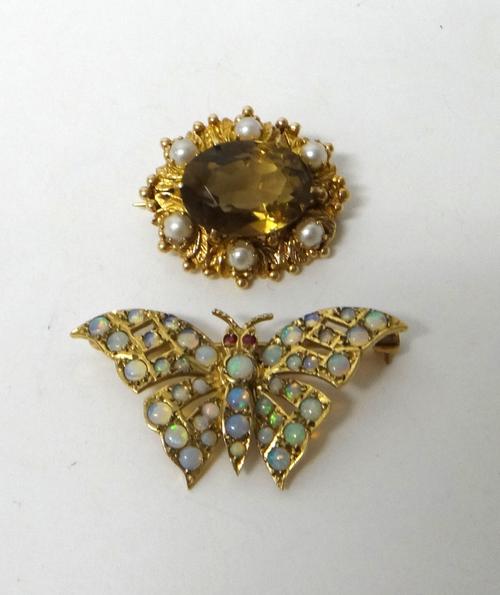 A 9ct gold and opal set brooch, designed as a butterfly, with ruby set eyes and a 9ct gold, citrine and cultured pearl set oval brooch, claw set with