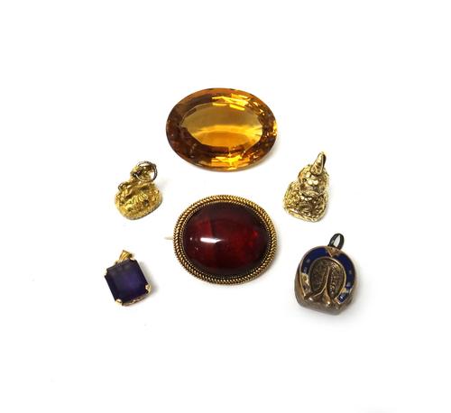 A Victorian gilt metal seal, with a lion motif, a Victorian chalcedony set seal, with a crest and motto to the base, a gold pendant, claw set with a r