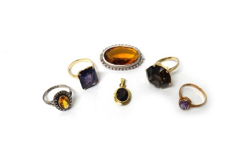 A 9ct gold ring, claw set with a circular cut smoky quartz, a 9ct gold ring, mounted with an oval cut amethyst, a gold ring, claw set with a rectangul