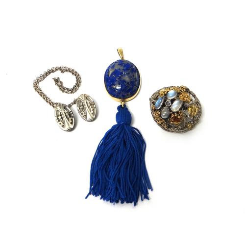 A silver and gilt, moonstone set brooch, of shaped circular form, with leaf motifs, a pair of Sterling silver oval clips, connected by an oval link ch