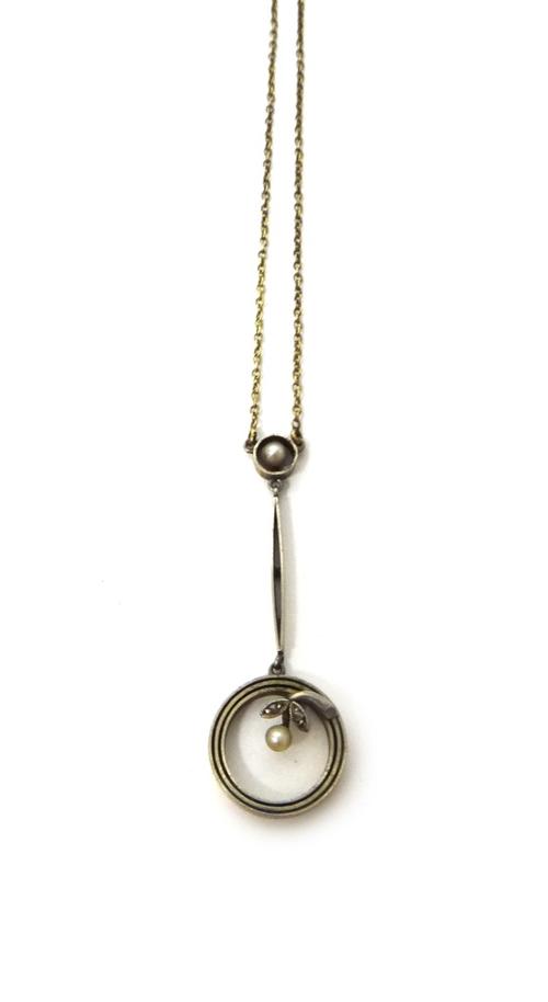 A gold, rose diamond and seed pearl set pendant necklace, the front with a spray motif within a circular surround to the drop, detailed 15 CT, on a tr