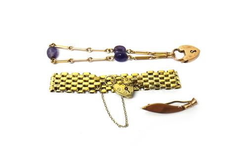 A gold and amethyst quartz bracelet, in a bar and circular link design, on a 9ct gold heart shaped padlock clasp, Birmingham 1906, a silver gilt oval
