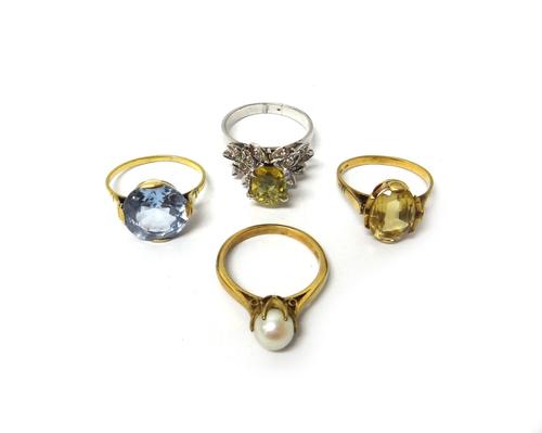 A gold ring, claw set with a cultured pearl, a gold ring, claw set with an oval cut citrine, a pale blue gem set solitaire ring and a diamond and pale