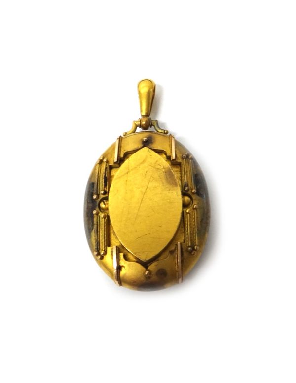 A Victorian gold oval pendant locket, glazed with locket compartments within, the front with applied bead and ropetwist wirework decoration in a class