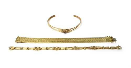 A 9ct gold bracelet, in a wide brick link design, on a gold clasp, detailed 375 9K, import mark London 1978, length 18cm, weight 26 gms, a 9ct gold br