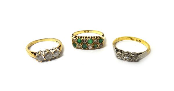 A gold, emerald and diamond set ring, in a two row design, mounted with six cushion shaped diamonds alternating with six emeralds, a 9ct gold and diam