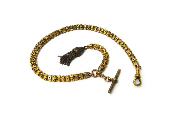 A Victorian gold watch chain, in a star pierced multiple link design, detailed 15 C, fitted with a swivel, a T bar and with an associated pendant tass