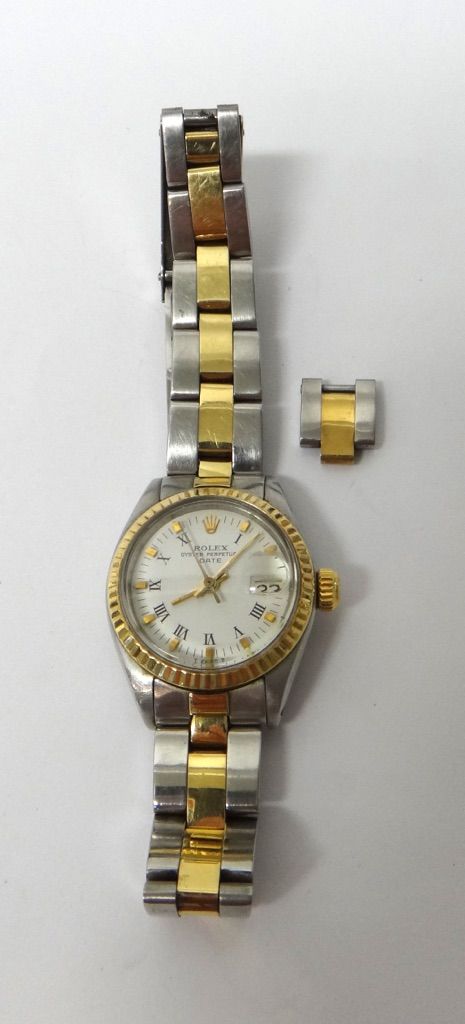 A lady's steel and gold Rolex Oyster Perpetual Date bracelet wristwatch, the signed white dial with black Roman numerals and with applied baton marker