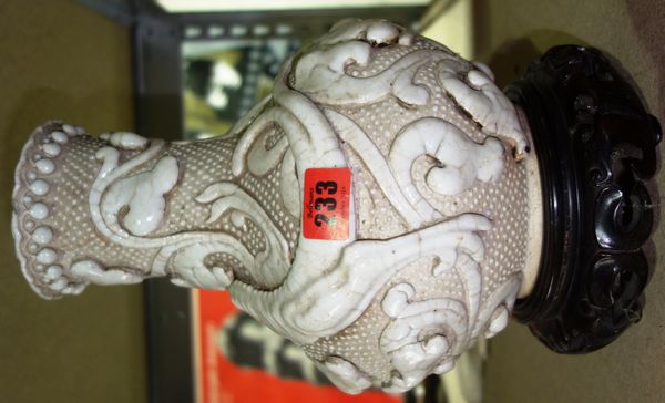 A 20th century white glazed Chinese vase with moulded dragon decoration.  CAB