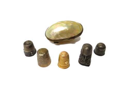 A European gold thimble, decorated with an engine turned band, an unmarked silver thimble, initial engraved E D, possibly late 17th century, a filigre