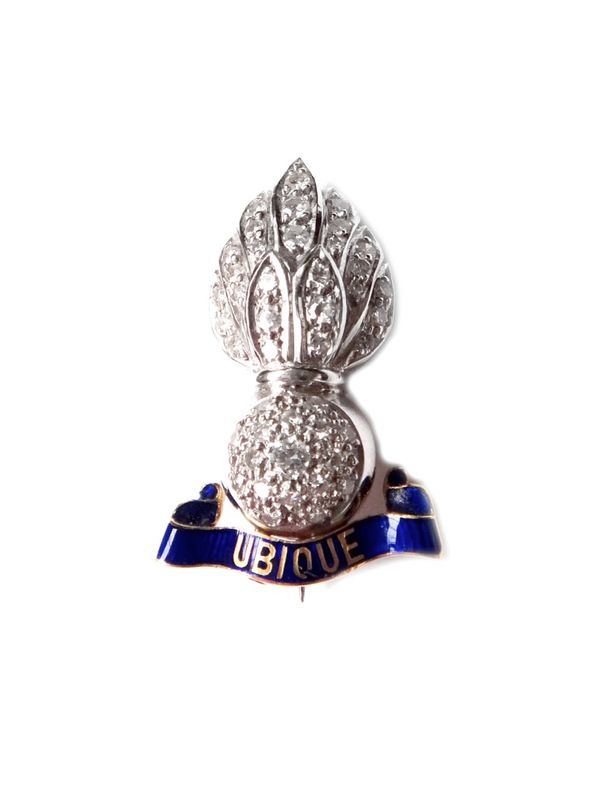 A gold, diamond set and blue enamelled military sweetheart's brooch, designed as a flaming grenade, mounted with circular cut diamonds, with the motto