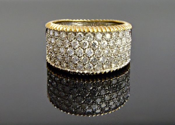 An 18ct two colour gold and diamond set band ring, mounted with five rows of circular cut diamonds, between decorated edges, ring size Q and a half, w