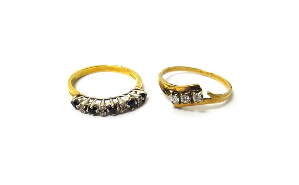 A gold and diamond set three stone ring, claw set with circular cut diamonds in a crossover design, ring size S and a half and an 18ct gold, sapphire