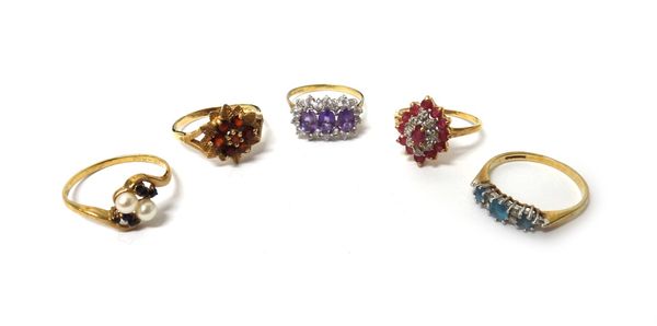 A 9ct gold and garnet set cluster ring, designed as a flowerhead, a 9ct gold ring, claw set with a row of three oval cut amethysts in a colourless gem