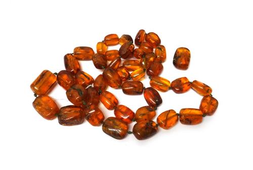 A single row necklace of graduated reconstituted translucent irregular amber beads and one further loose bead, gross combined weight 190 gms.