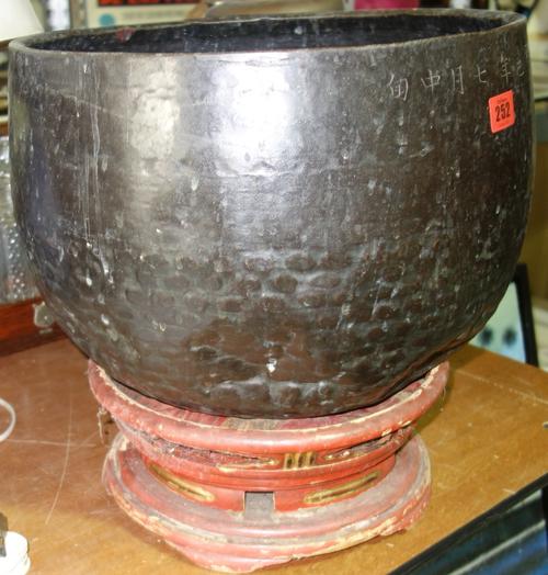 A large Oriental copper fish bowl with red lacquer and gilt stand inscribed with characters.  C7