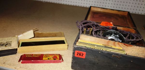 An early 20th century small cased magic lantern and a quantity of slides.  CAB