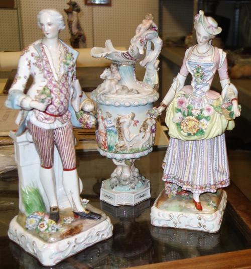 A pair of Continental ceramic figures of a man and a woman and a Continental figural decorated ewer, (3). S1T